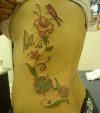 butterfly and flower vine pic tattoo on side back